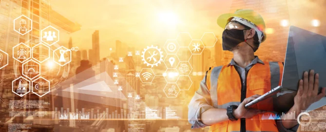 Man Construction Worker Wearing A Mask While Holding A Computer.